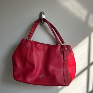 Red COACH bag, crossbody strap included.